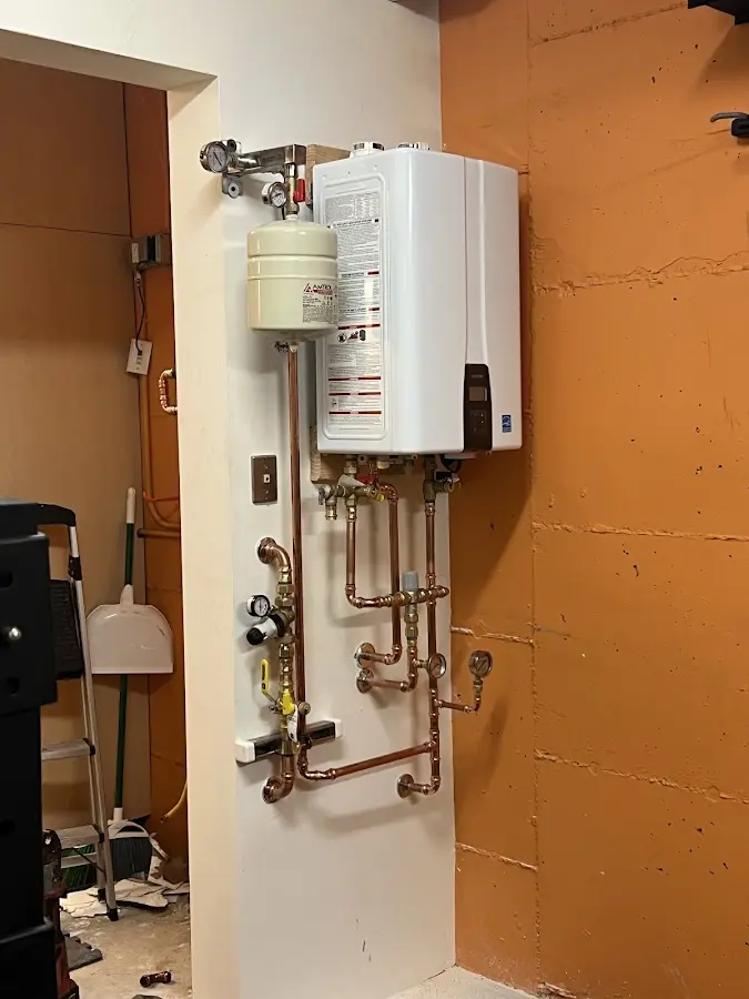 Plumbing technician inspecting water heater connections in Ceres
